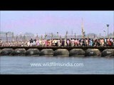 Pilgrims crossing the River Ganges on a pontoon bridge
