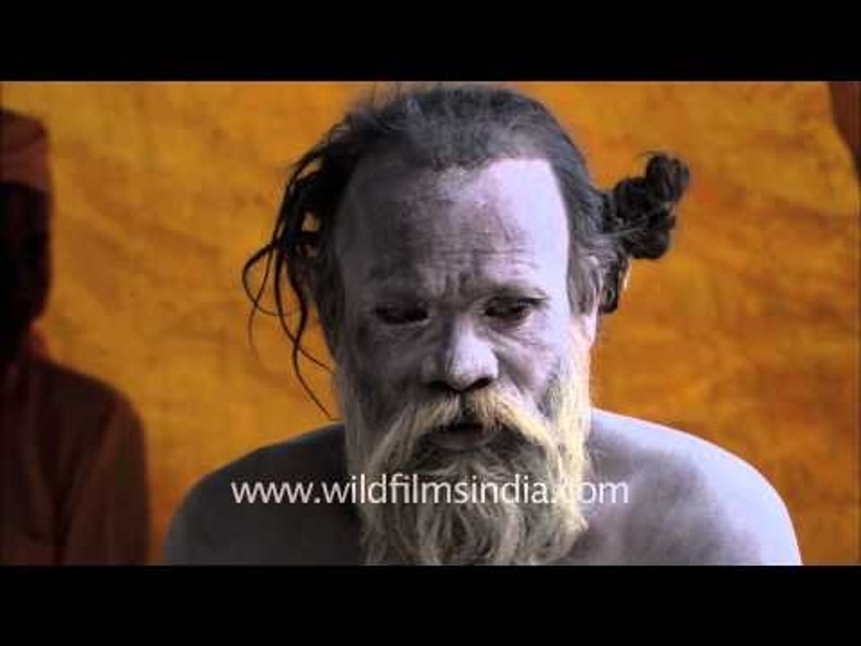 Naga baba chatting with friends on mobile phone...