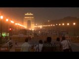 Traffic passing around India Gate at dusk