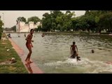 Young boys swim and perform for the camera, Delhi