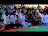 Devotees gathered at Kirtan on the banks of river Ganga during Maha Kumbh