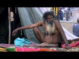 Naga Sadhu poses beside a tent in Varanasi