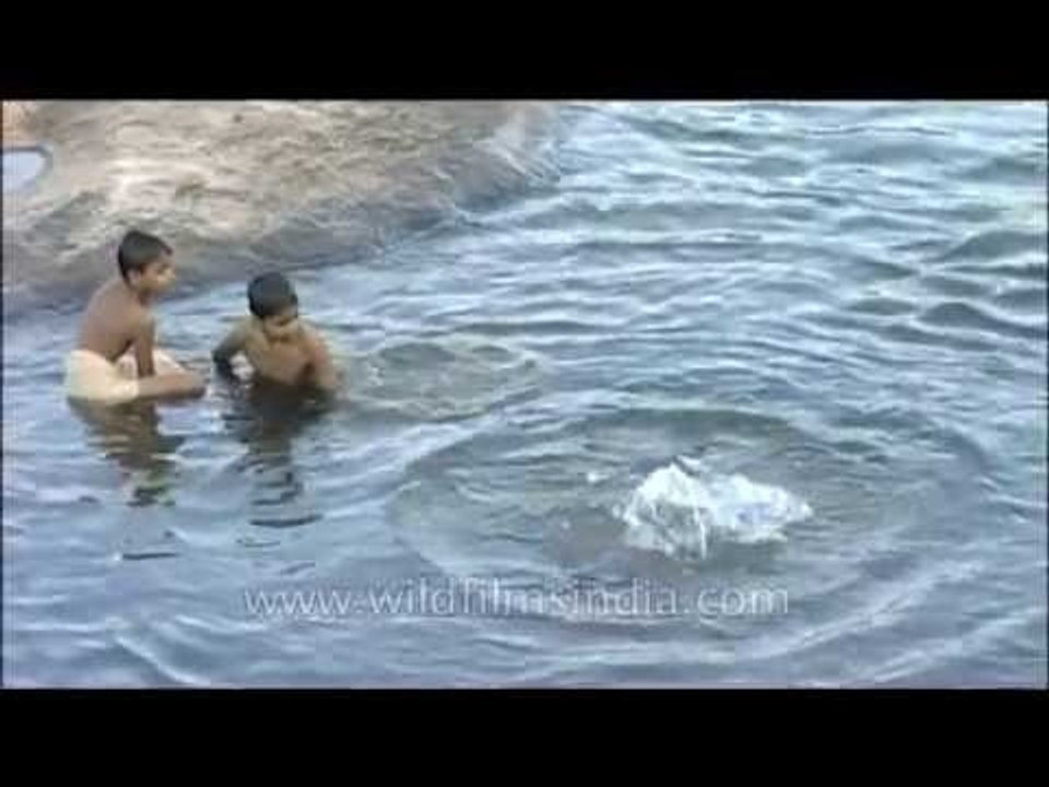 Young boys swimming in a river in Kerala