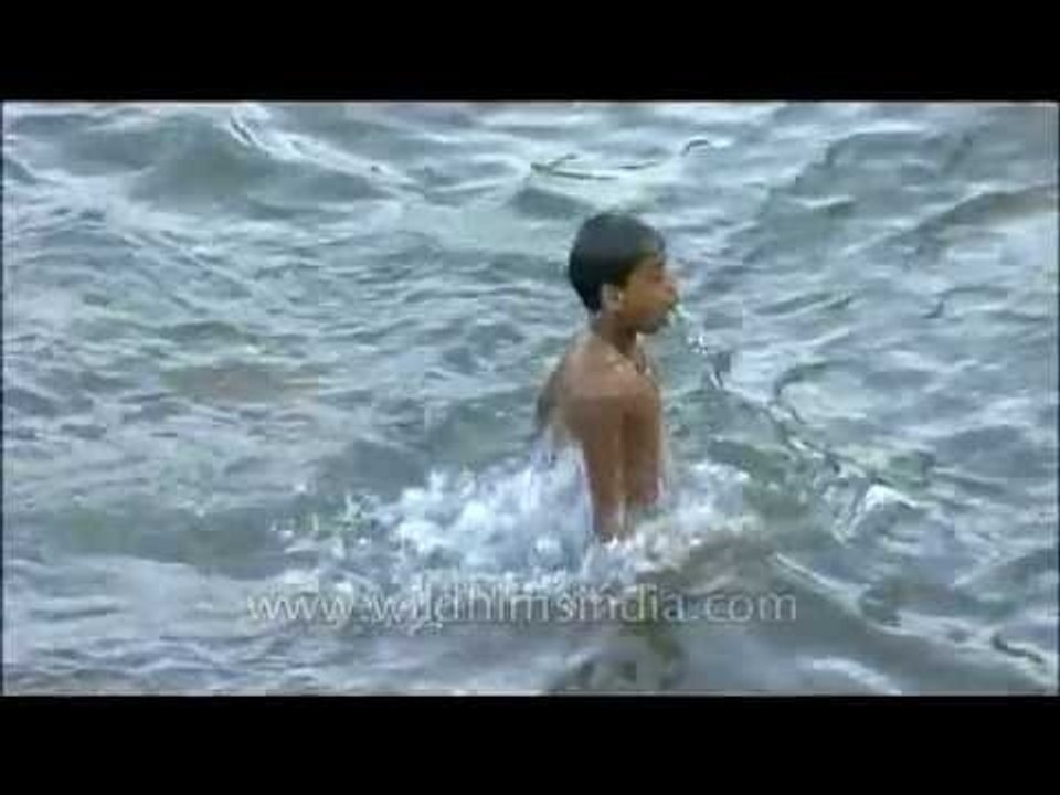 Children splashing around in a river in Kerala