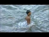 Children splashing around in a river in Kerala