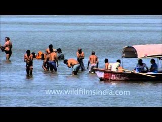 Devotees play like children when supposedly in the Ganga for a holy bath