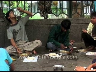 People enjoying food at roadside dhaba