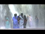 Ladies wearing sarees getting wet under waterfalls in Kerala : Thirparappu