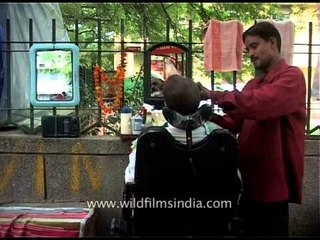 Road-side barber works the streets of New Delhi