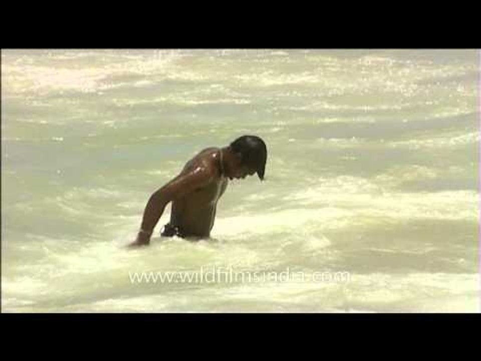 Fisherman taking a bath in the sea water
