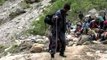 Nanda Devi Expedition members prepares to cross a dangerous stream