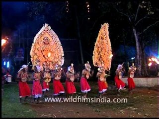 Men in red white lungis dancing Koodithullal at Padayani Festival
