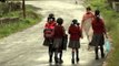 Children walk home on rain drenched roads in Cherapunji