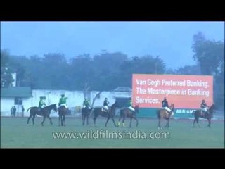 Eyes on the ball and hands firmly holding reins Players chase the Ball