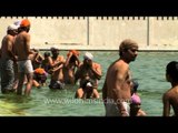 Sikh devotees taking holy dip during Vaisakhi at  Gurudwara Takht Sri Kesgarh Sahib, Punjab