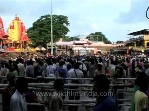 Three richly decorated chariots at the Ratha Yatra procession in Puri, Odisha