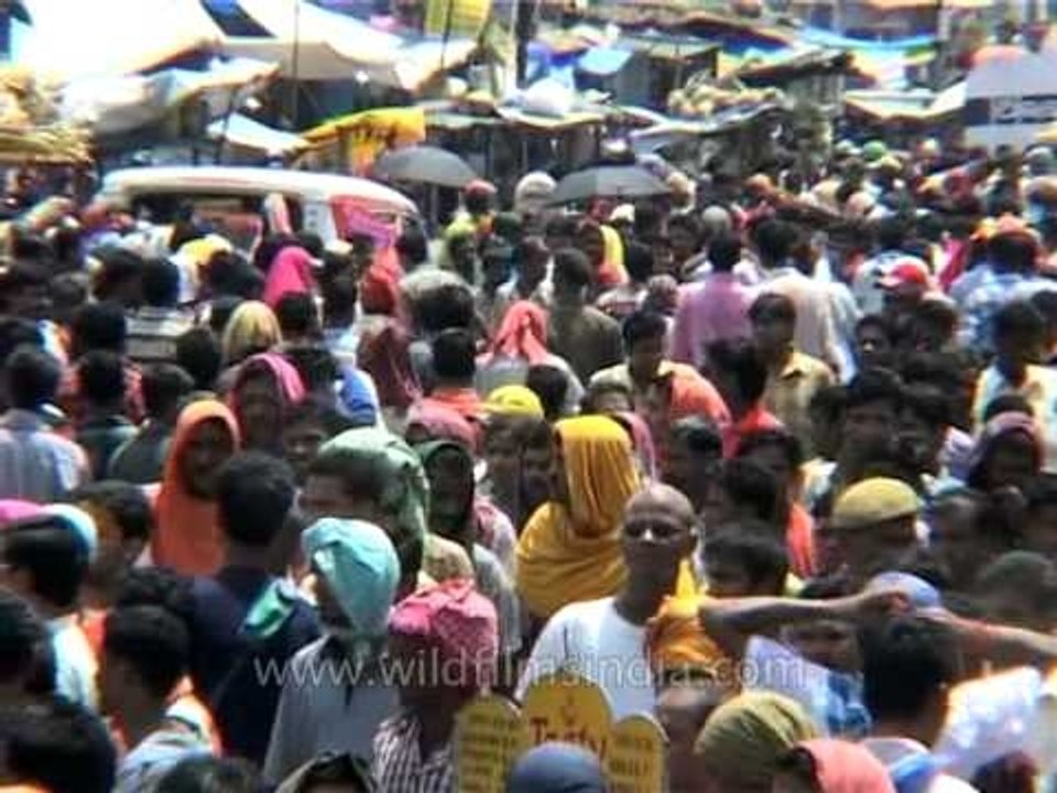 Volunteers carry an unconscious devotee on a stretcher at the Rath Yatra in Puri