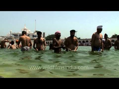 Sikh devotees take a dip in the sarovar at Takht Sri Keshgarh Sahib during Vaisakhi.