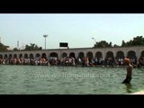 Devotees paying obeisance and taking holy dip in Sarovar at Gurudwara Takht Sri Kesgarh Sahib