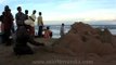 Sand artist sculpting the portrait of a lady by the Bay of Bengal, Puri