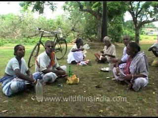 Old people having lunch break in a park, Orissa