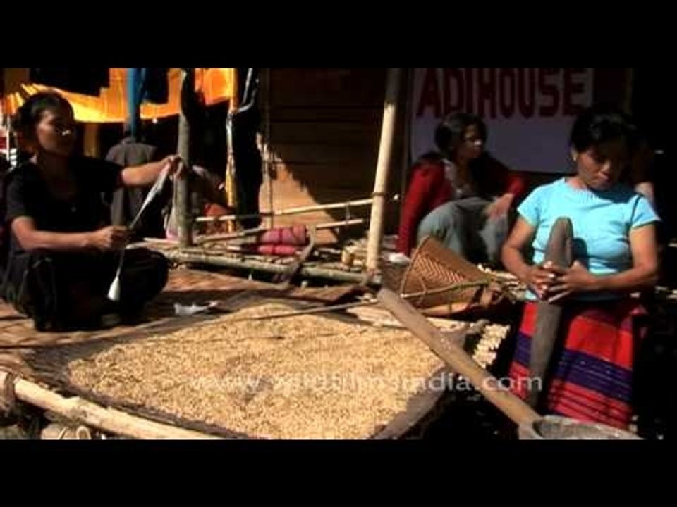 Adi women of Arunachal pounding corn and spinning cotton
