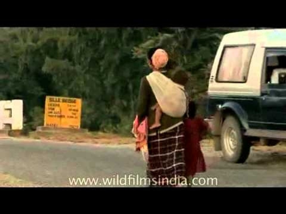 Arunachali woman carries child in cloth sling
