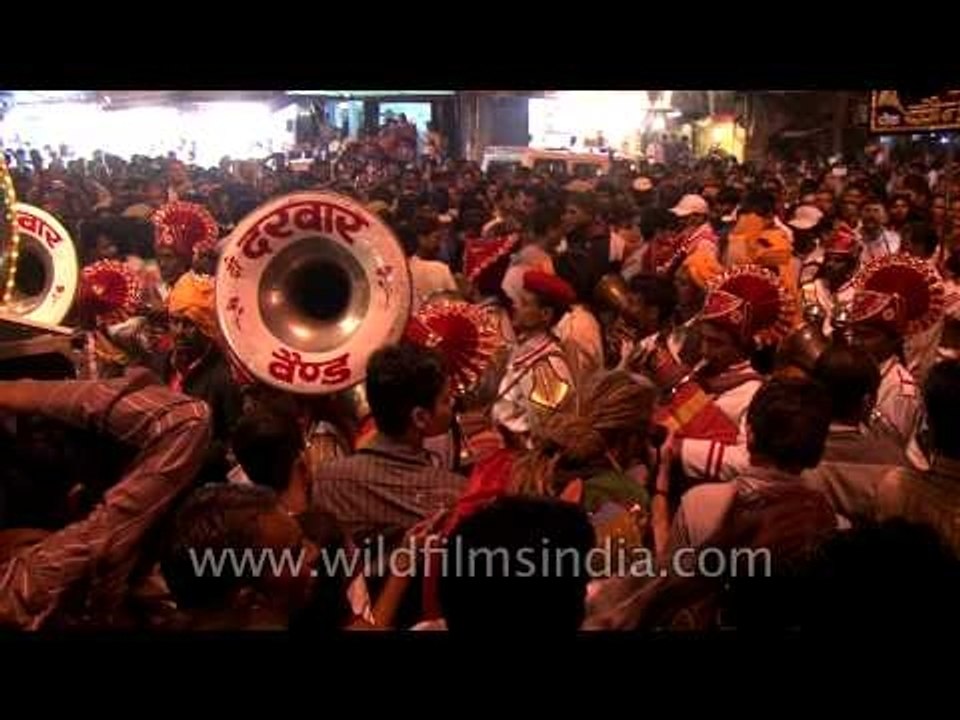 Colourfully illuminated wedding bands taking part at the Mahashivratri procession, Varanasi