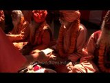 Varanasi Bhandara - Sadhus offered with money during the meal