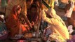 Priest performing Hindu rituals with new born baby and his family during Maha shivratri at varanasi