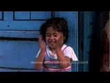 Cute little Nepali girl blushes at the camera