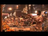 Hindu priests holding lit up Multi-tiered aartis during Ganga Aarti, Varanasi