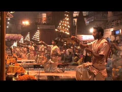 Hindu priests holding lit up Multi-tiered aartis during Ganga Aarti, Varanasi