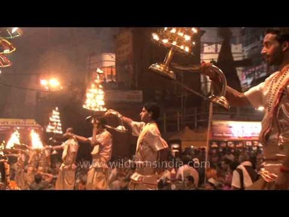 Multi tiered lamps being raised by HIndu priests during Ganga Aarti in Varanasi