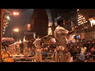 Multi - tiered aarti raised by priests at the evening Ganga Aarti in Varanasi