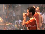 Priests blowing 'Shankh' before ganga aarti at Banaras