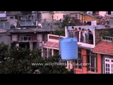 Nepali people looking down from a balcony in Kathmandu