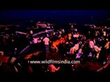 Devotees arrive by boat for the Agni Pooja or Varanasi Ganga Aarti