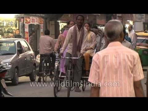 Cycle rickshaws and motor vehicles in a busy street in Varanasi, India