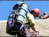 Instructors giving rock climbing lessons to school students in Manali
