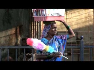 A roadside peddler sellling duster in the streets of Mumbai