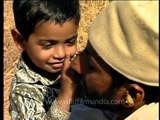 Maldhari man plays with his child