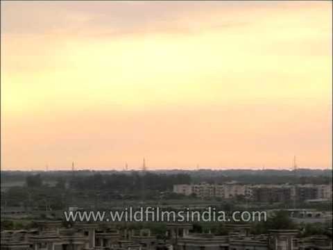 Red cloudy sky over the residential areas near Delhi Airport