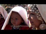 Little girl with her mother in traditional dress at Kangdali festival