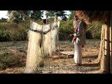 Fishermen making a fishing net along the Brahmaputra river