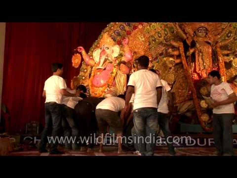 Devotees, dismentaling Durga Puja pandal