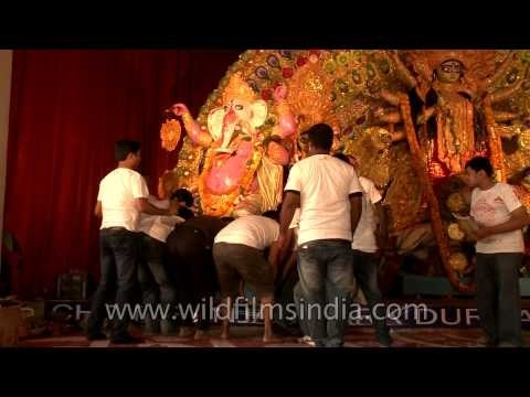 Devotees, dismentaling Durga Puja pandal