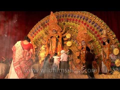 Devotees gather in front of puja pandal to worship Goddess Durga during Durga puja