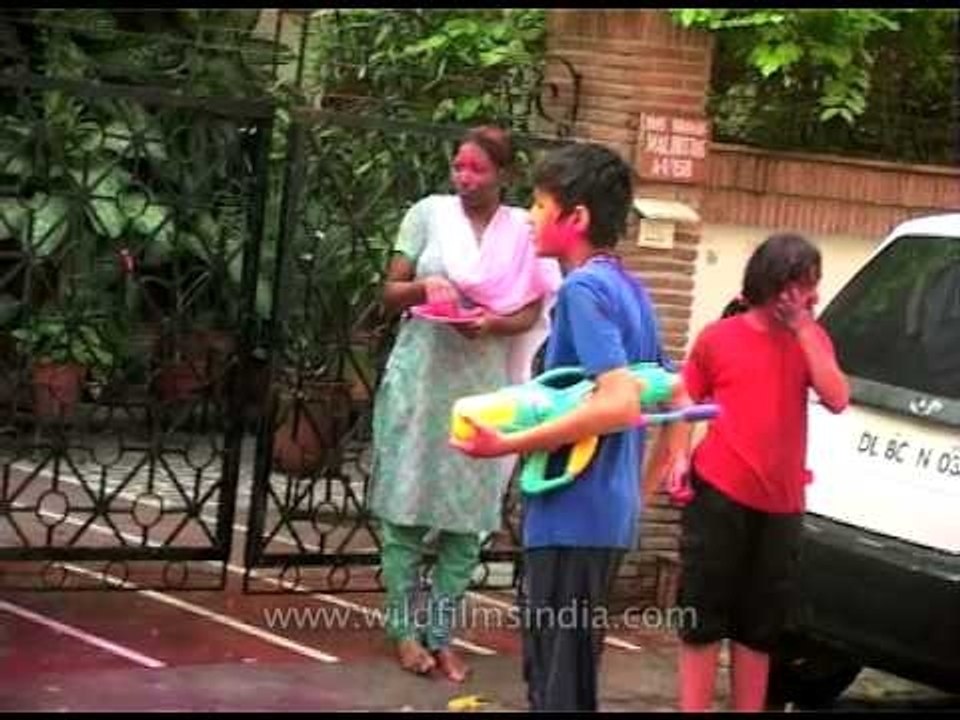 Splashing bucketfuls of colored liquids on loved ones during Holi