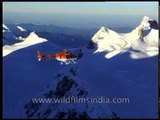 Chopper flying over the snow-capped mountains of Himalayan Range